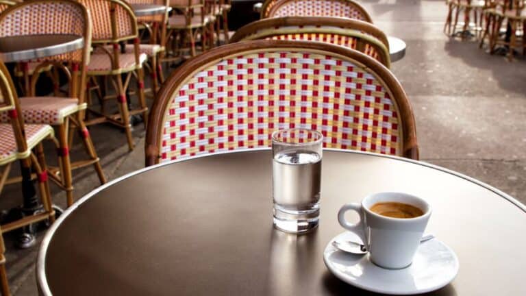 Un café et un verre d'eau sur une terrasse parisienne